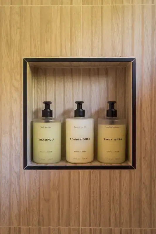Bath products in a tiled shower niche