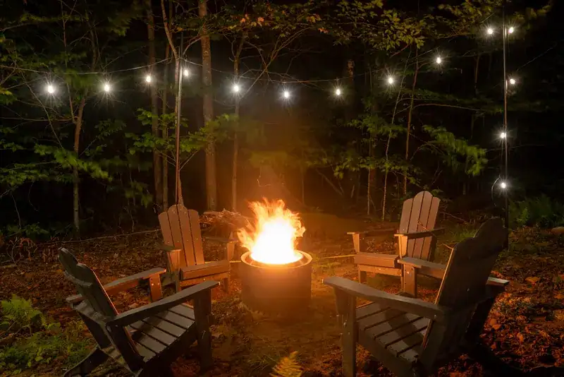 Chairs gathered around a fire at night