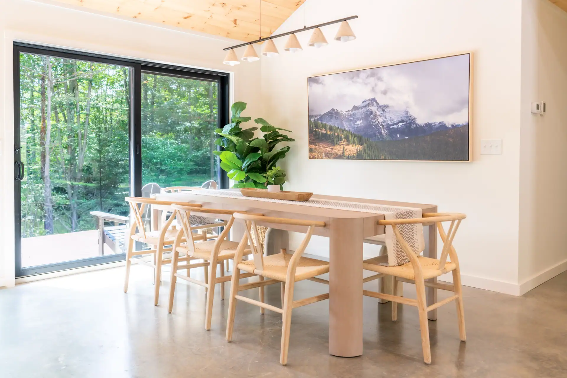 Dining table beside Casa Vetta's forest-facing windows