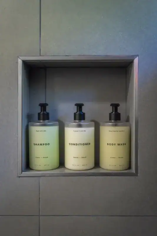 Bath products in a gray shower niche