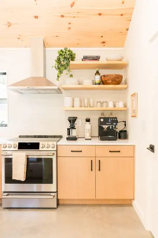 Kitchen with range, open shelves, and coffee station