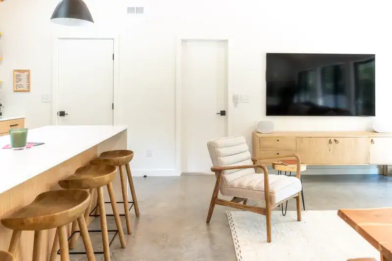 Living area with TV and kitchen island stools