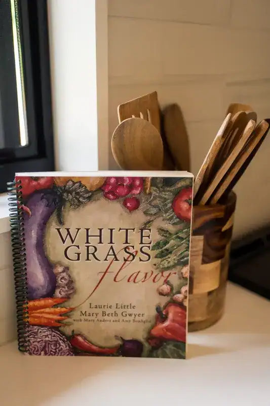 Cookbook and wooden utensils in the kitchen