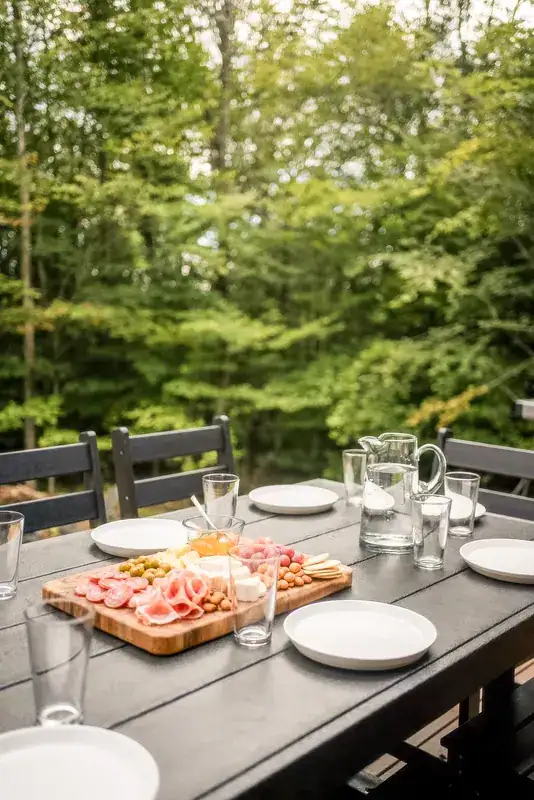 Outdoor table set for a meal among the trees