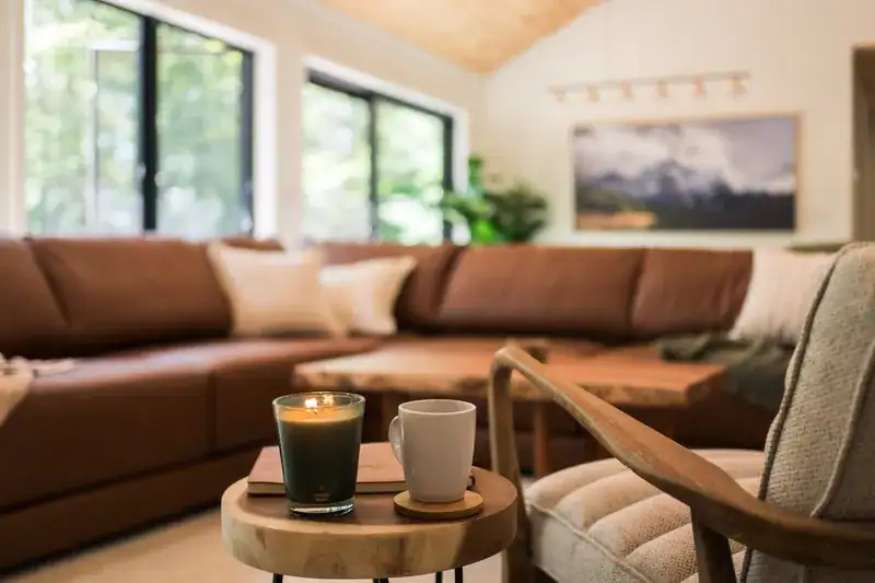 Coffee and candle beside the living room sofa
