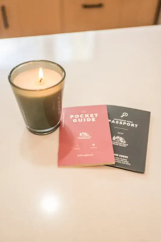 Candle and books on a side table