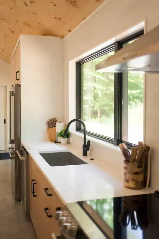 Kitchen sink beneath a wide window
